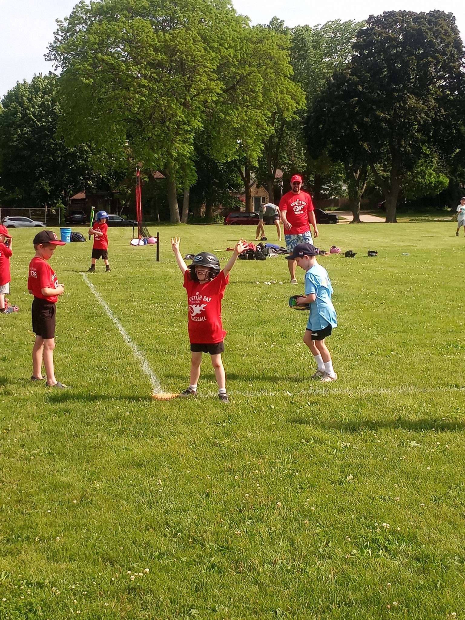 A young Whitefish Bay Baseball player celebrates after a hit at Armory Park